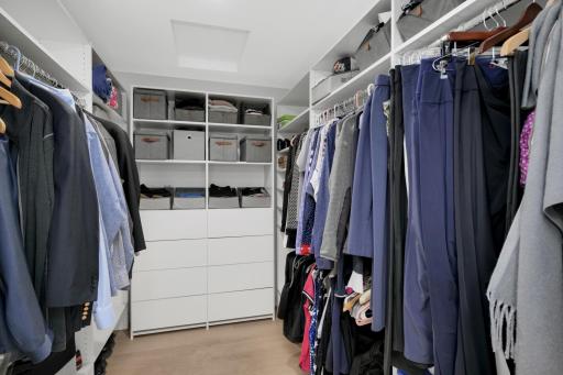 The primary suite walk-in closet with organizing system to keep everything organized.