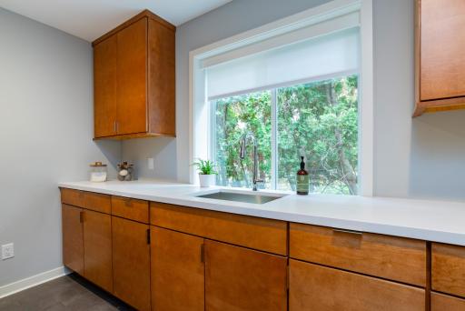 The main floor full laundry room with additional custom cabinets.
