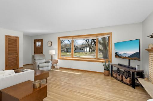 Classic hardwood floors and 50's brick fireplace lit with ample sunshine from your south facing picture window.
