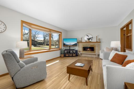 Classic hardwood floors and 50's brick fireplace lit with ample sunshine from your south facing picture window.