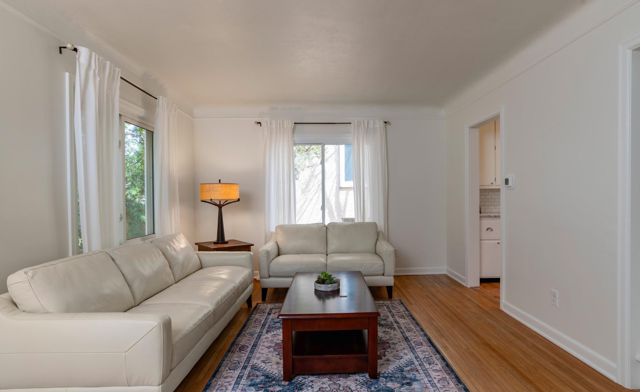 The large windows fill the living room with natural light.