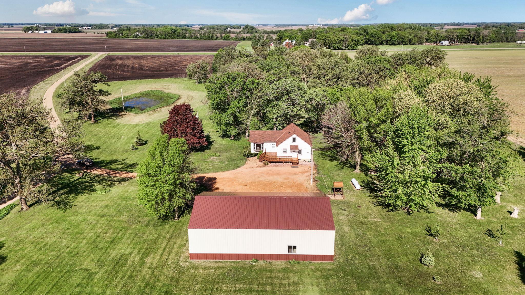 Beautiful country setting on 7.62 acres with mature trees, open views and a spacious 60 x 36 Shed