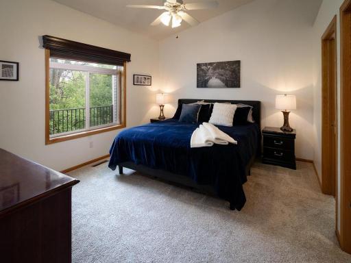 The primary bedroom features vaulted ceilings and a gorgeous view of the private backyard