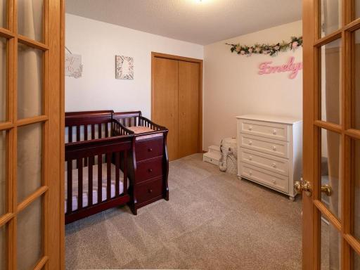 Use as a bedroom or an office, this front room features French doors.