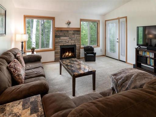 Cozy up next to the fire and enjoy the privacy of the wooded backyard