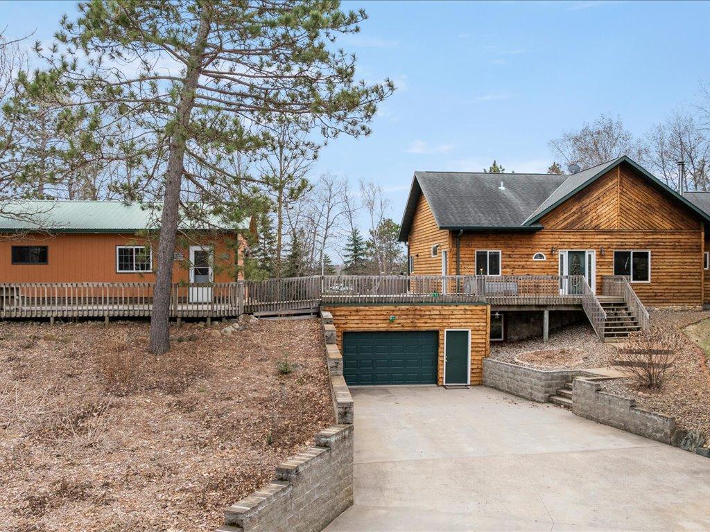 Tuck under garage with lower level entrance to flex room and into family room. Large deck between extra bunk house and the main home.