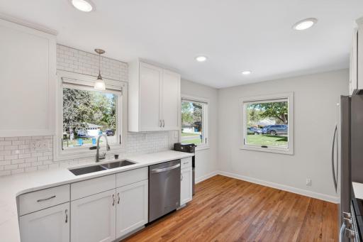 Quartz countertops, soft-close cabinetry, and matching stainless steel appliances.