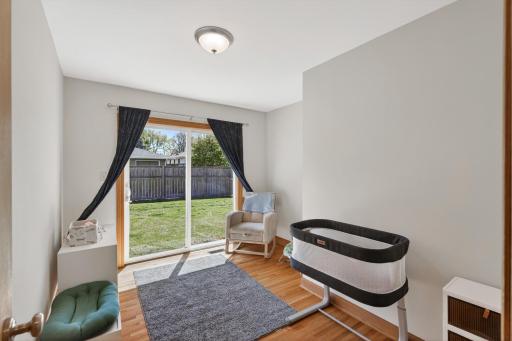 Main level bedroom with sliding glass door access to the backyard.