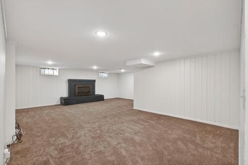 Comfortable lower-level retreat featuring a fireplace and lookout windows