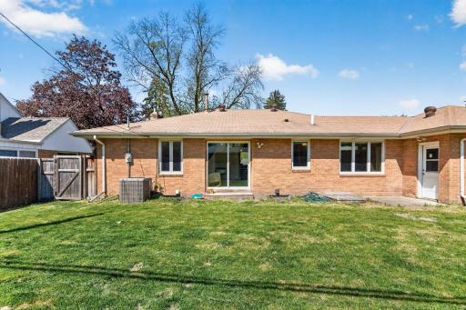 Flat backyard with space for entertaining, gardening, or play.