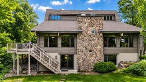 From the lakeside, the homes impressive architecture is complemented by expansive windows and beautiful views stretching down the property's unique peninsula setting.