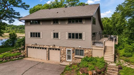 Thoughtfully designed to capture lake views, this impressive home offers generous living spaces, abundant windows, and seamless access to outdoor gathering areas.