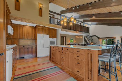 The spacious kitchen offers abundant cabinetry, a large center island, and seamless flow into the dining and living areas, making it ideal for entertaining.