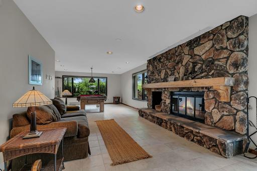 The lower level featuring a second stone fireplace, spacious family room and game area.