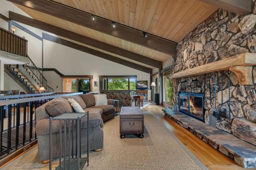 Floor to ceiling stone fireplace creates a warm and inviting gathering space.