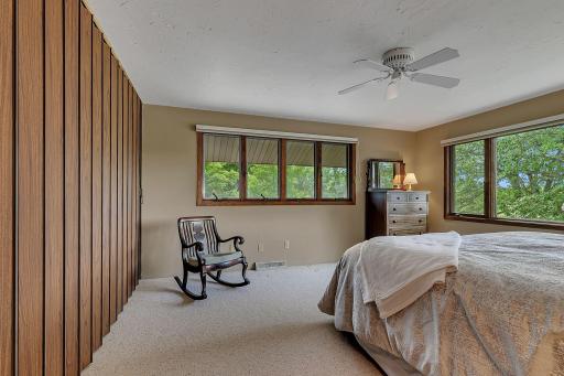 This alternate view highlights the flexibility of the upper level third bedroom, offering ample space to create a cozy seating area or productive work from home setup.