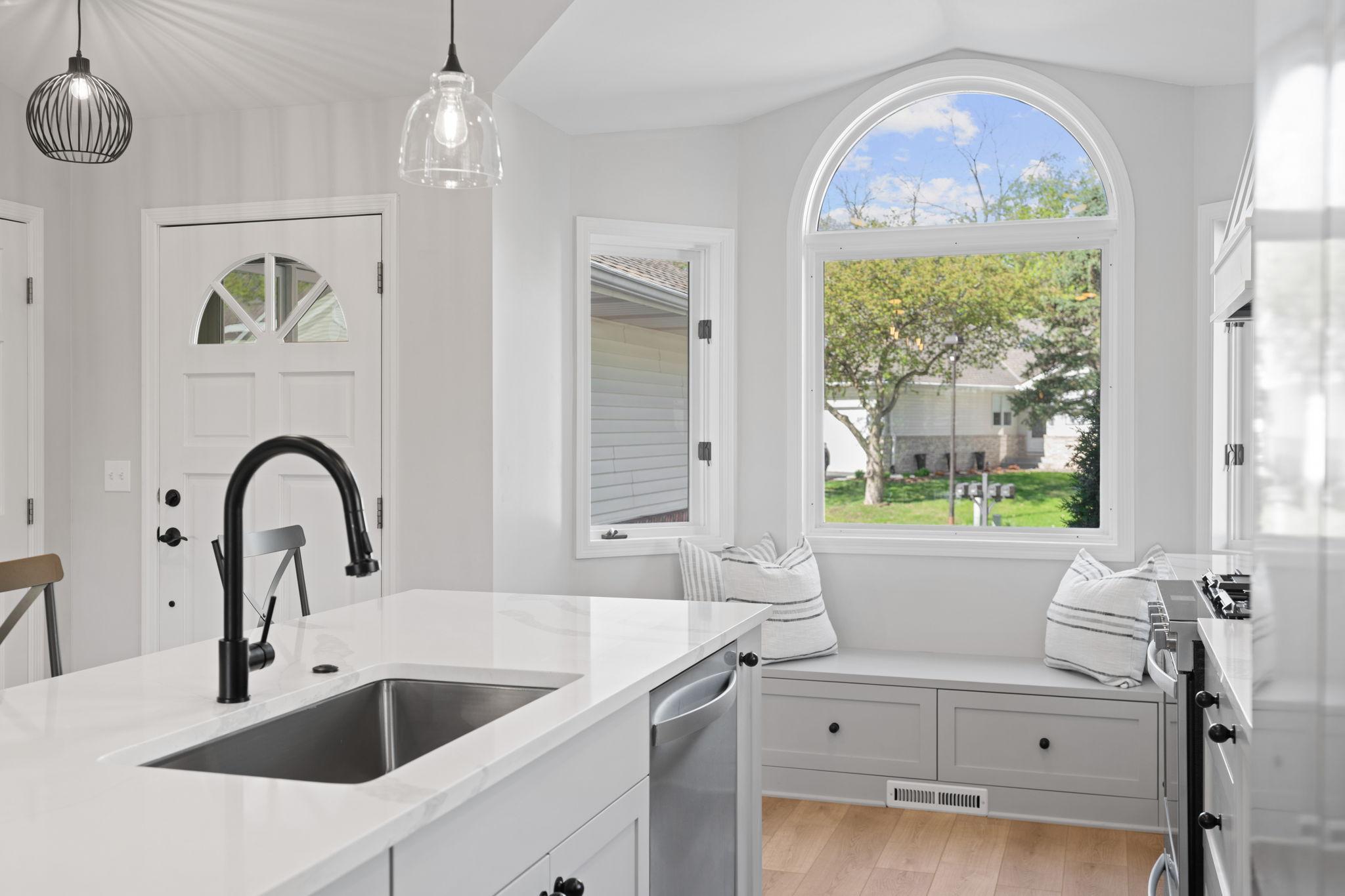 The front windows provide natural light and a cozy built-in seating area.