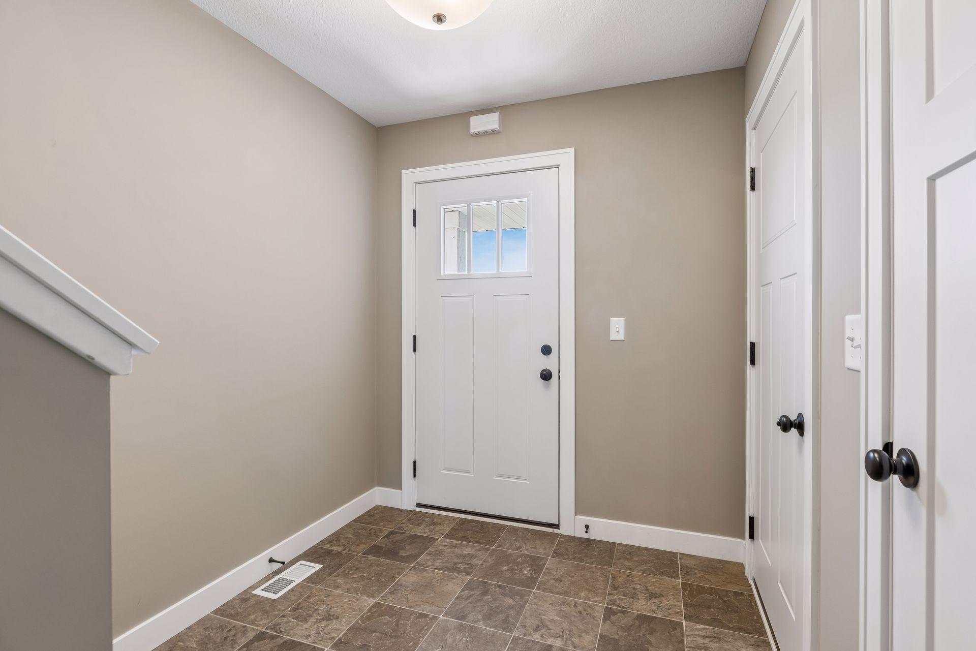 Spacious foyer with access to the 3 car garage, coat closet. Up to the main level or down to the unfinished lower level which is ready for your finishing touch!