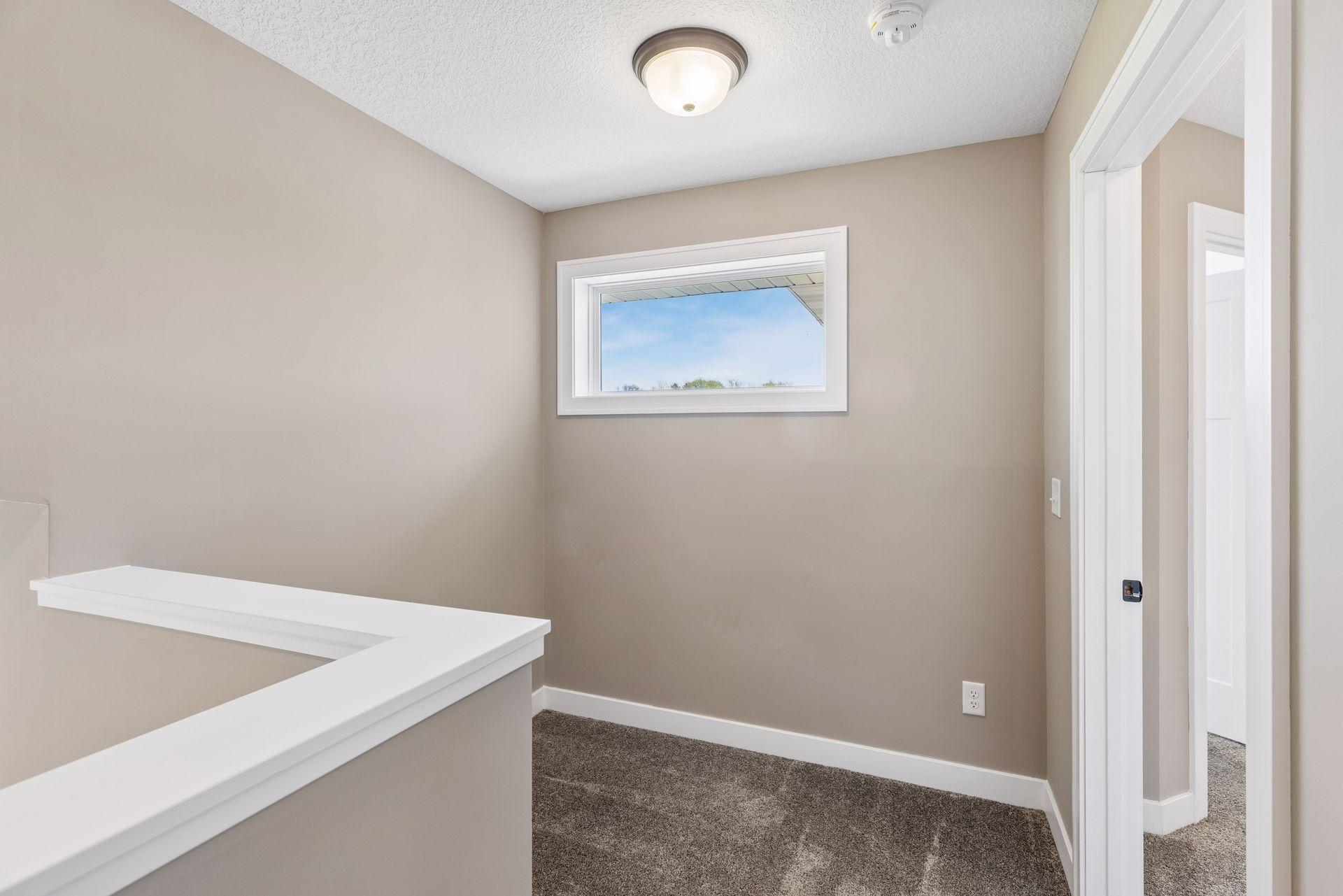 Upper level loft space just outside the primary suite - sellers used this as a home office work space, it could also be a great reading nook!