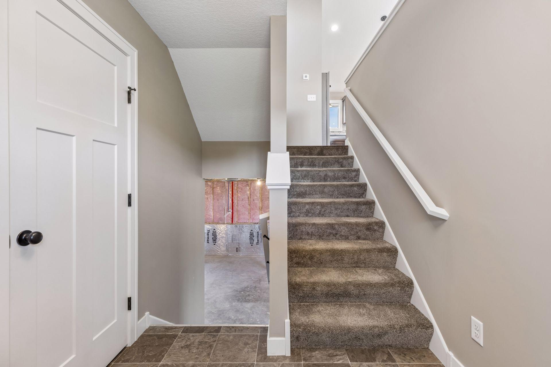 Another view of the foyer showing the access to the lower level and main level.