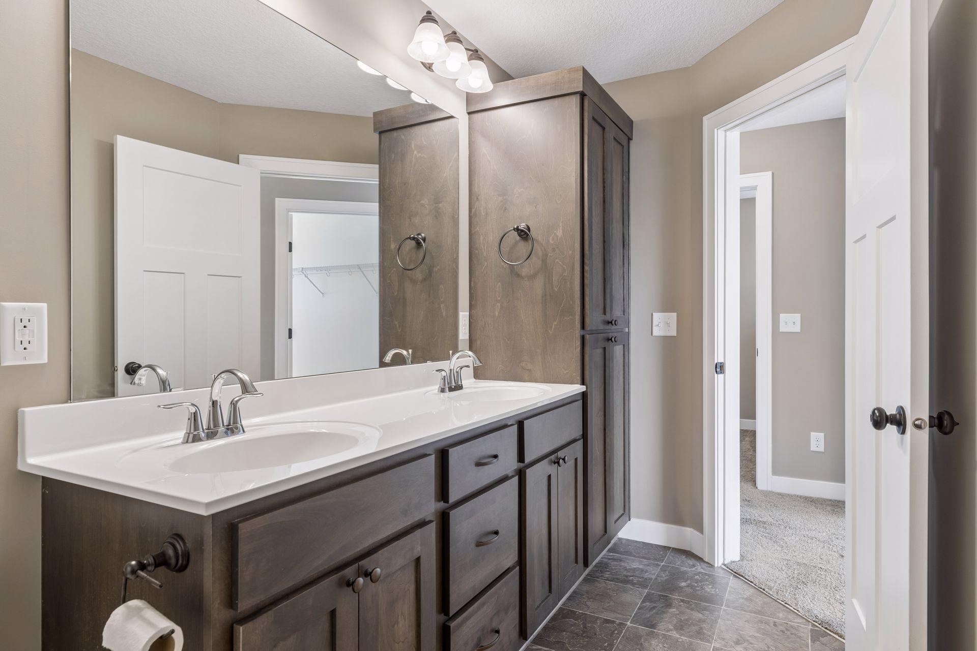 Primary private full bath with dual sink vanity and great storage.