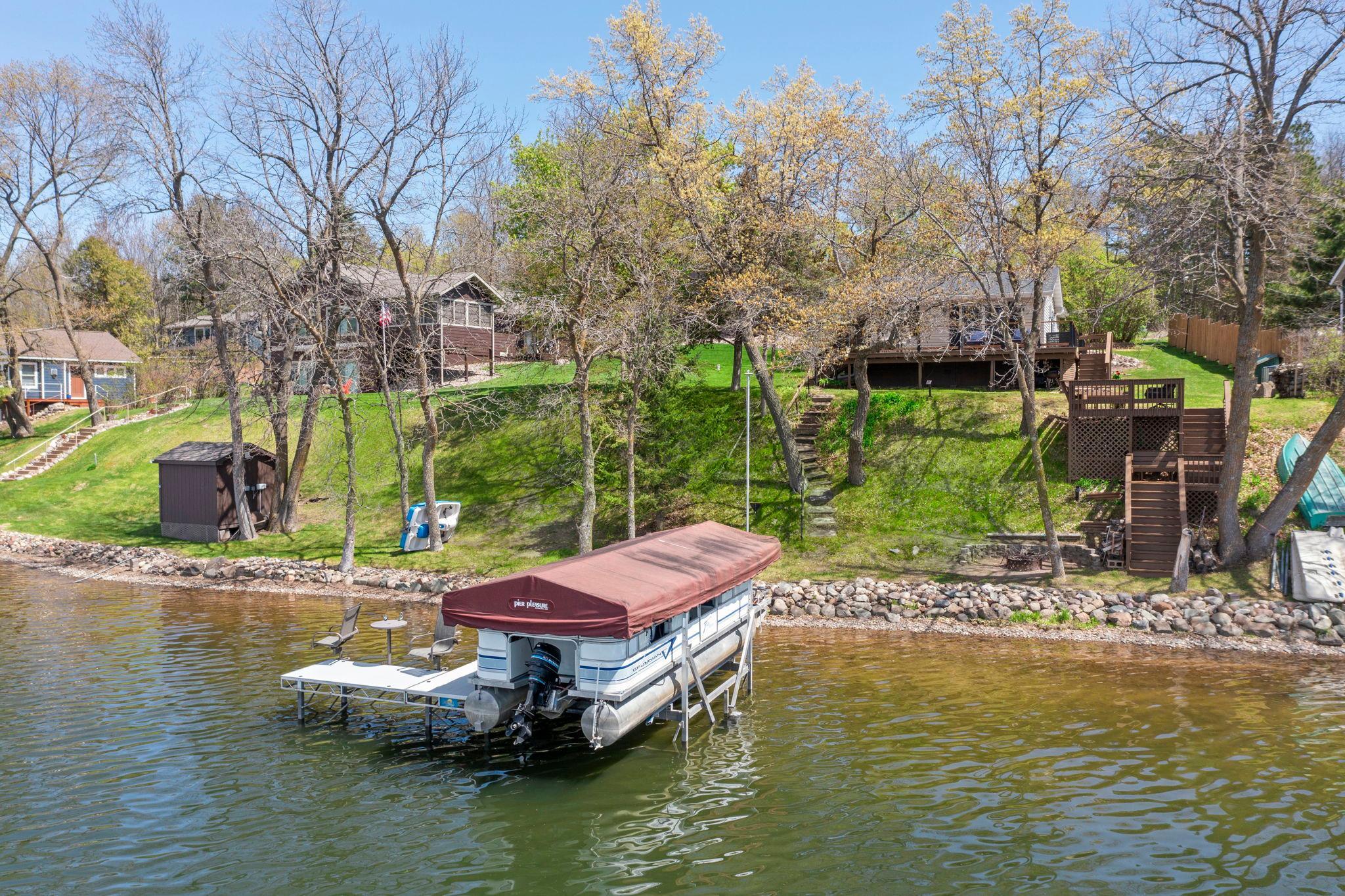 Fantastic view of lake shore looking to the home. Dock, boatlift and pontoon are all set for your summer fun!