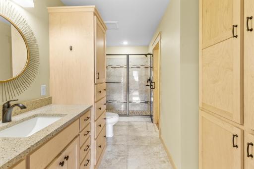 Custom Maple cabinets, quartz countertops and plentiful storage. The shower features beautiful tile, elegant tile flooring as well.