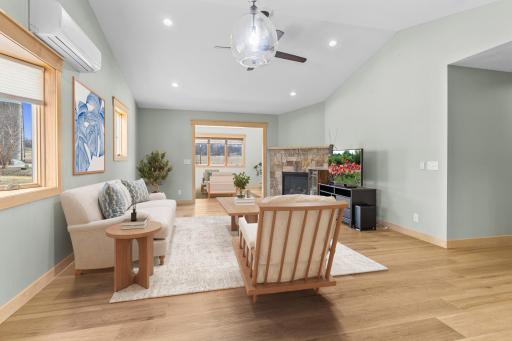 The light-filled Living Room offers a great space to relax in front of the cozy fireplace. (Virtually staged).
