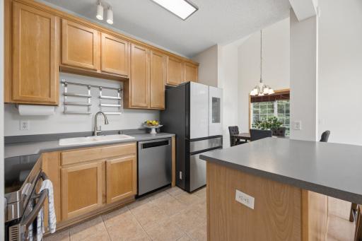 Kitchen features light cabinetry and newer appliances