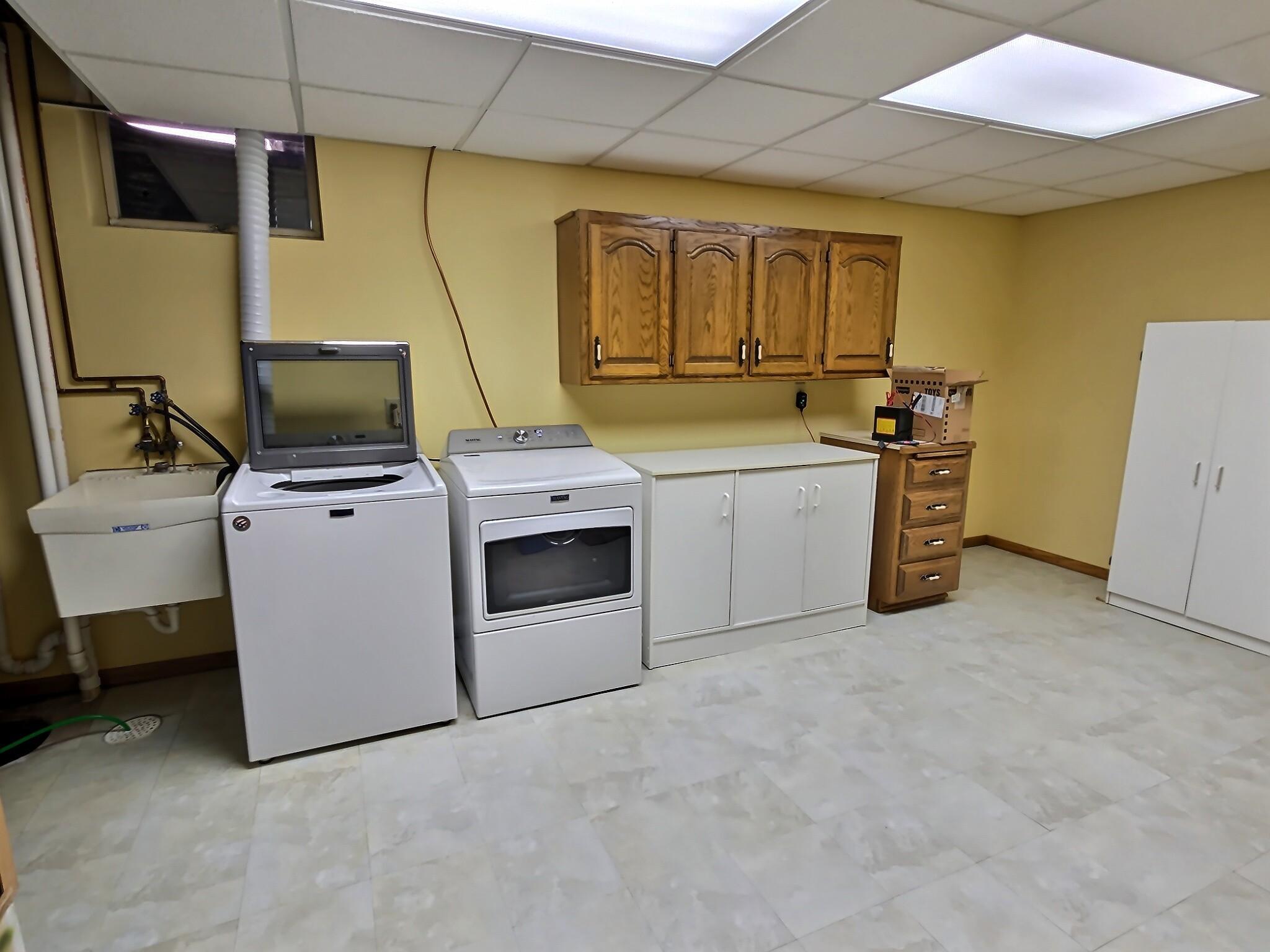 A spacious laundry room designed for both function and convenience, offering plenty of room to move and stay organized. Doubling with the mechanical room, this space is roomy enough for a large folding table.