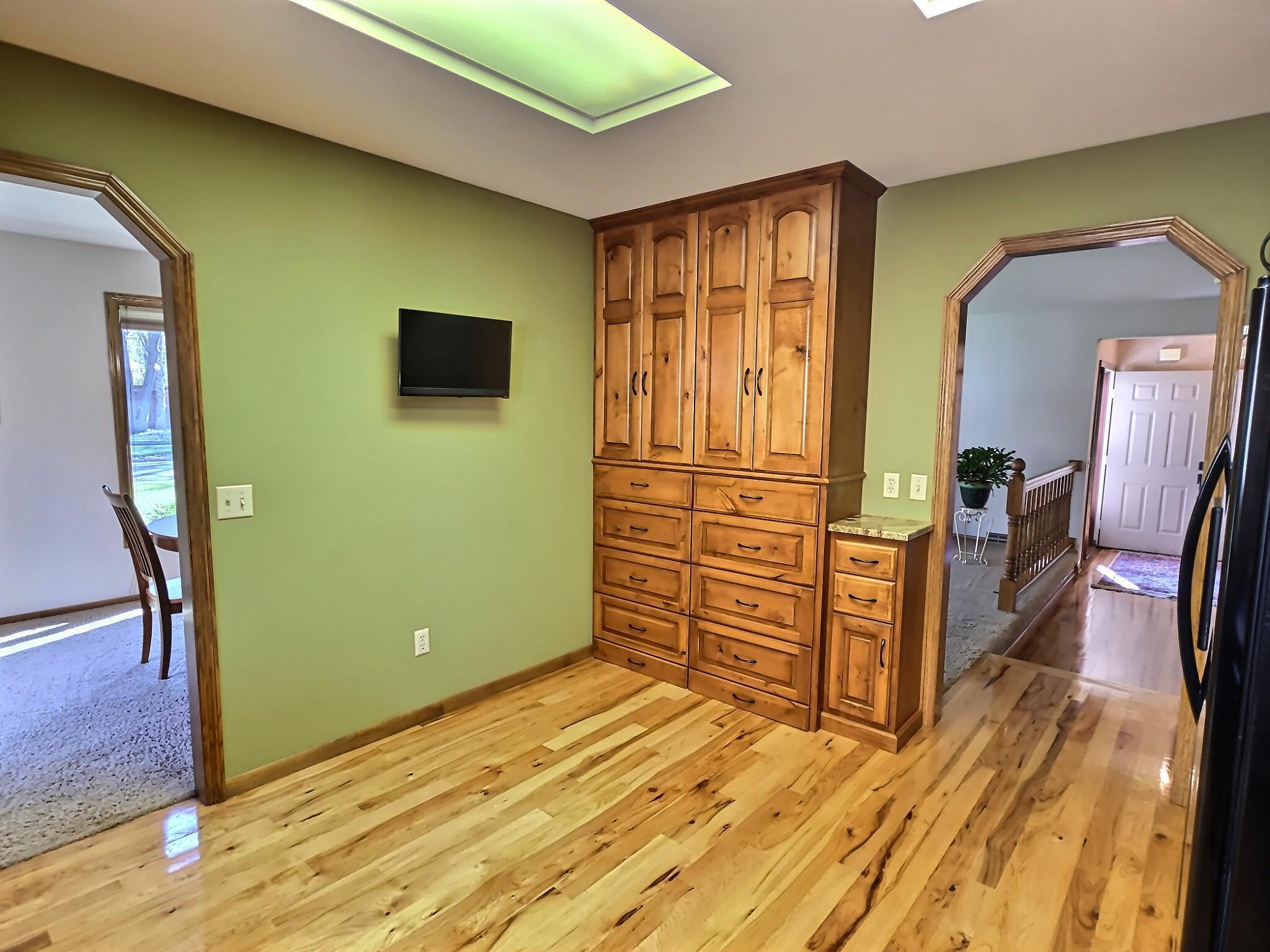 Hardwood floors run throughout, bringing warmth underfoot and tying the space together. The extra storage cabinets and pullouts are definitely an added bonus!