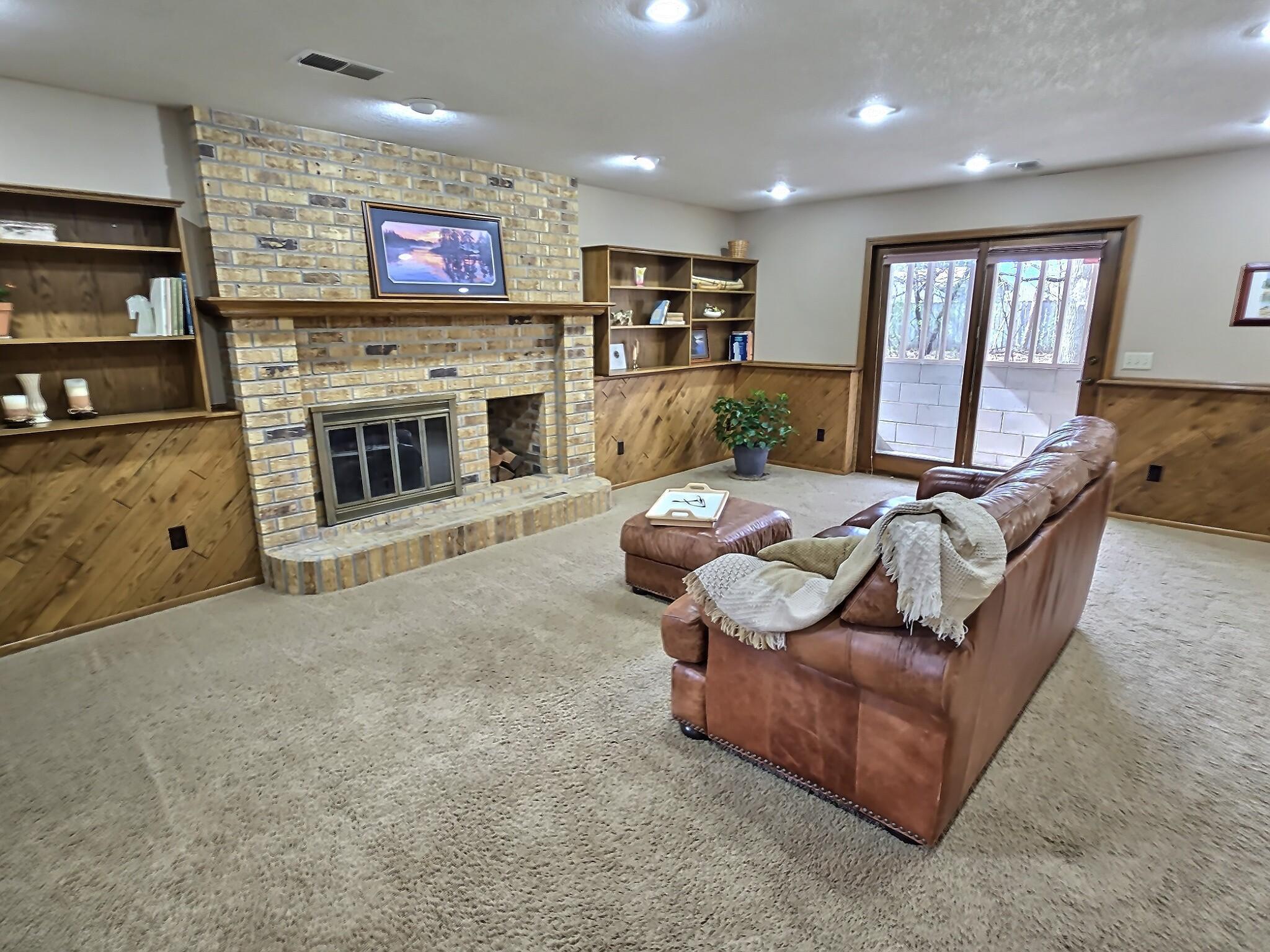 The walkout lower level offers a warm and welcoming family room with direct access to the backyard, along with a third bathroom—ideal for guests or gatherings.
