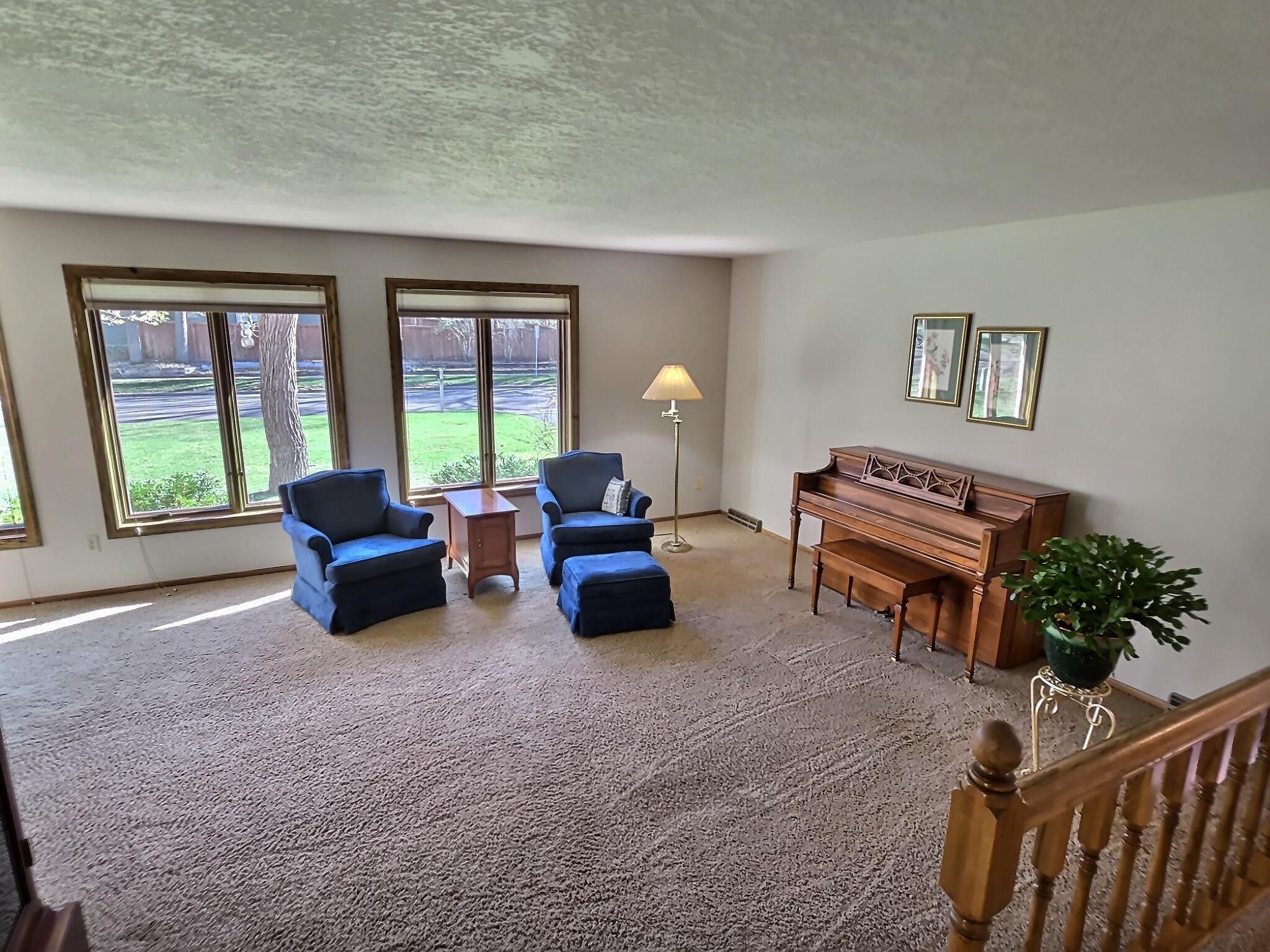 Numerous windows line the space, filling both areas with abundant natural light and creating a bright, airy atmosphere throughout the day.