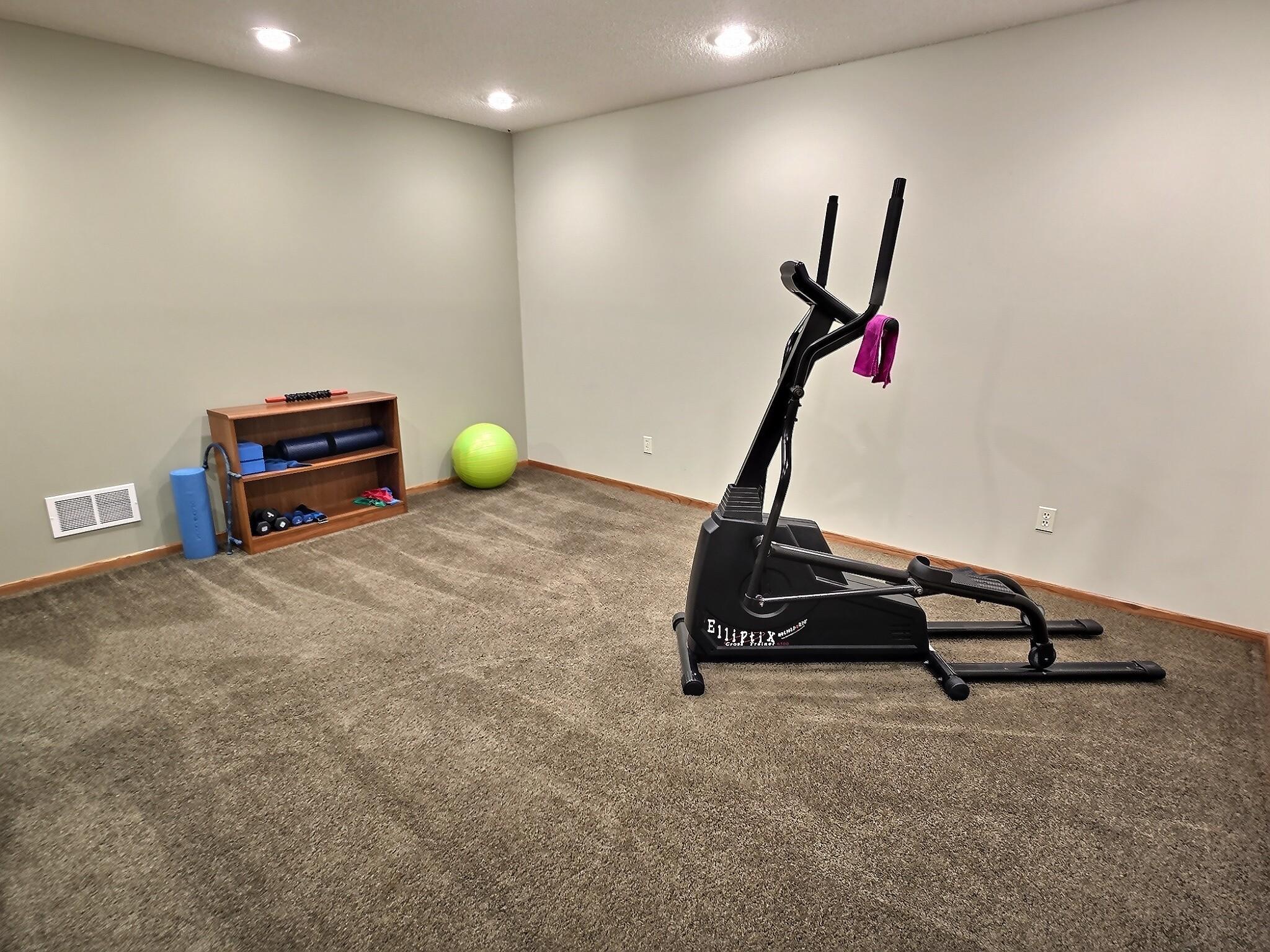 This inviting area offers plenty of room for workout equipment, yoga mats, or a creative setup, with a layout that adapts easily to your needs.