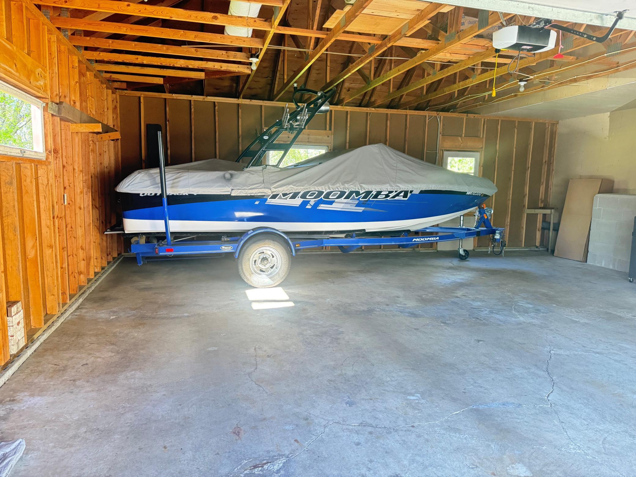 An oversized attached garage offering exceptional space and versatility, large enough to comfortably accommodate a boat along with vehicles and equipment. The natural light bounces off the concrete floors. Boat NOT INCLUDED!