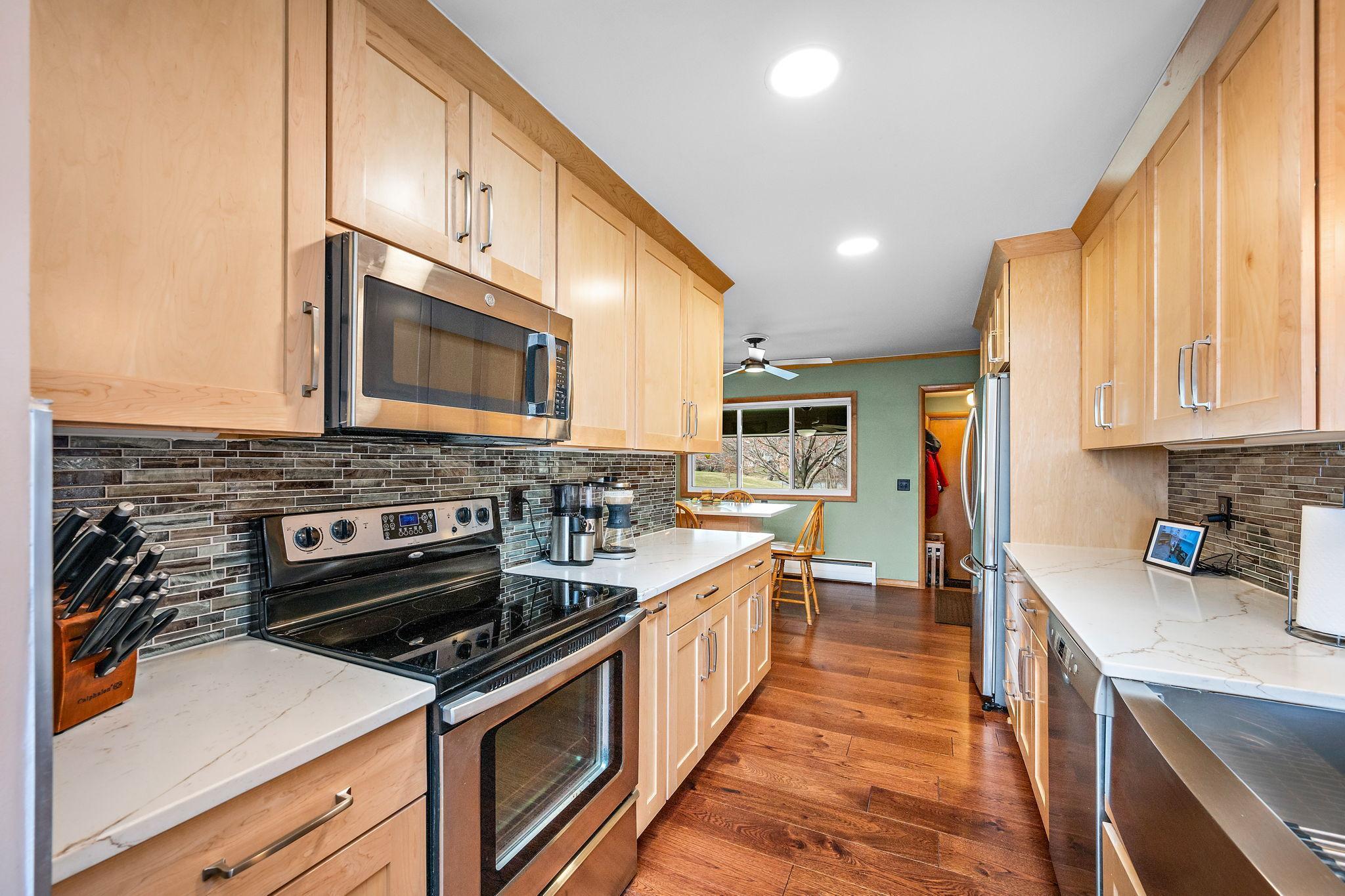 Stainless appliances, quartz counters, tile backsplash, beautiful cabinets featuring 42” uppers, pull out cabinet drawers, and soft close doors and drawers!