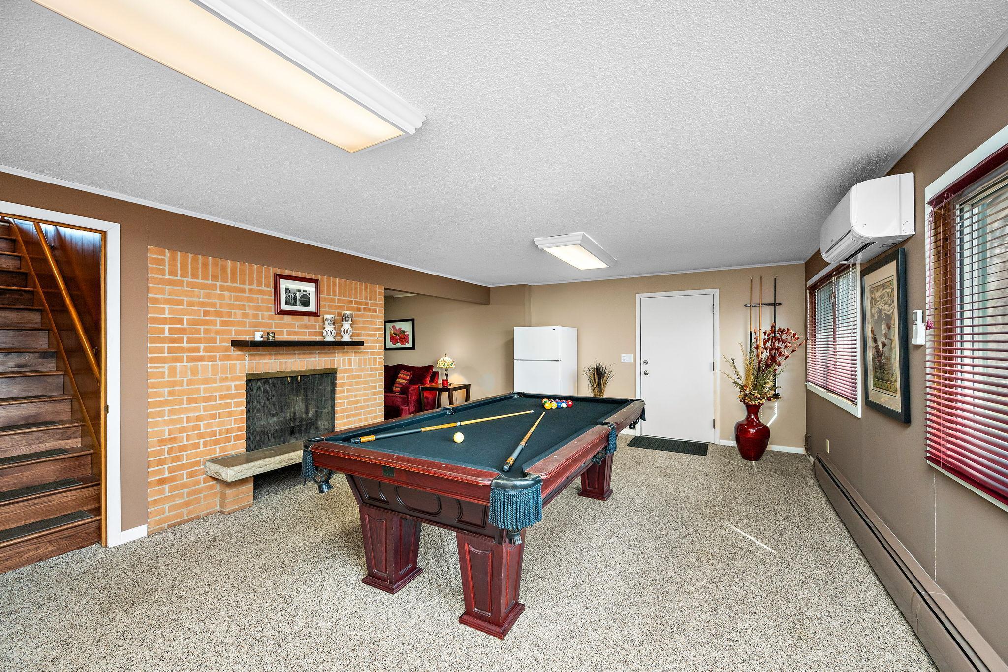 Sizeable entertaining space with lots of light from this walkout basement! (the fridge, pool table, and accessories will stay with the home)