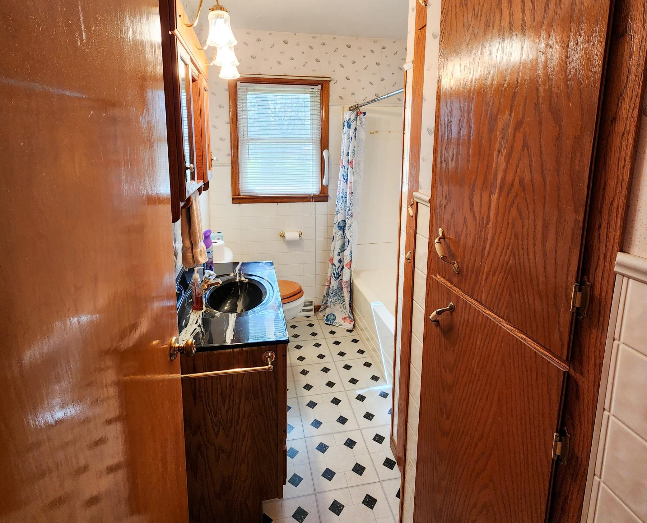 Main Floor Bathroom with Tub and Shower and plenty of storage.jpg