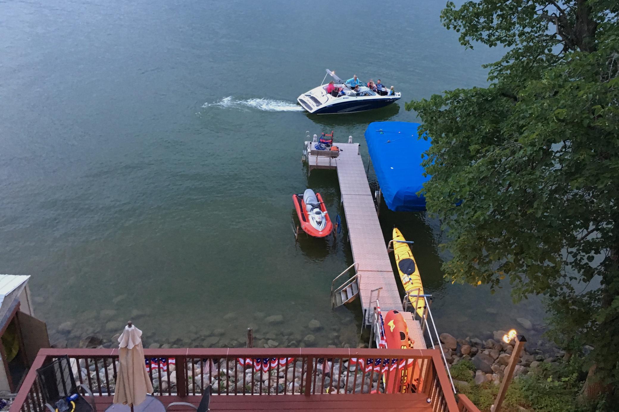View of summer fun on the lake with 82 feet of beautiful private shoreline on Lake Koronis. Ideal for your dock, swimming, or launching kayaks on this deep, island-dotted lake.