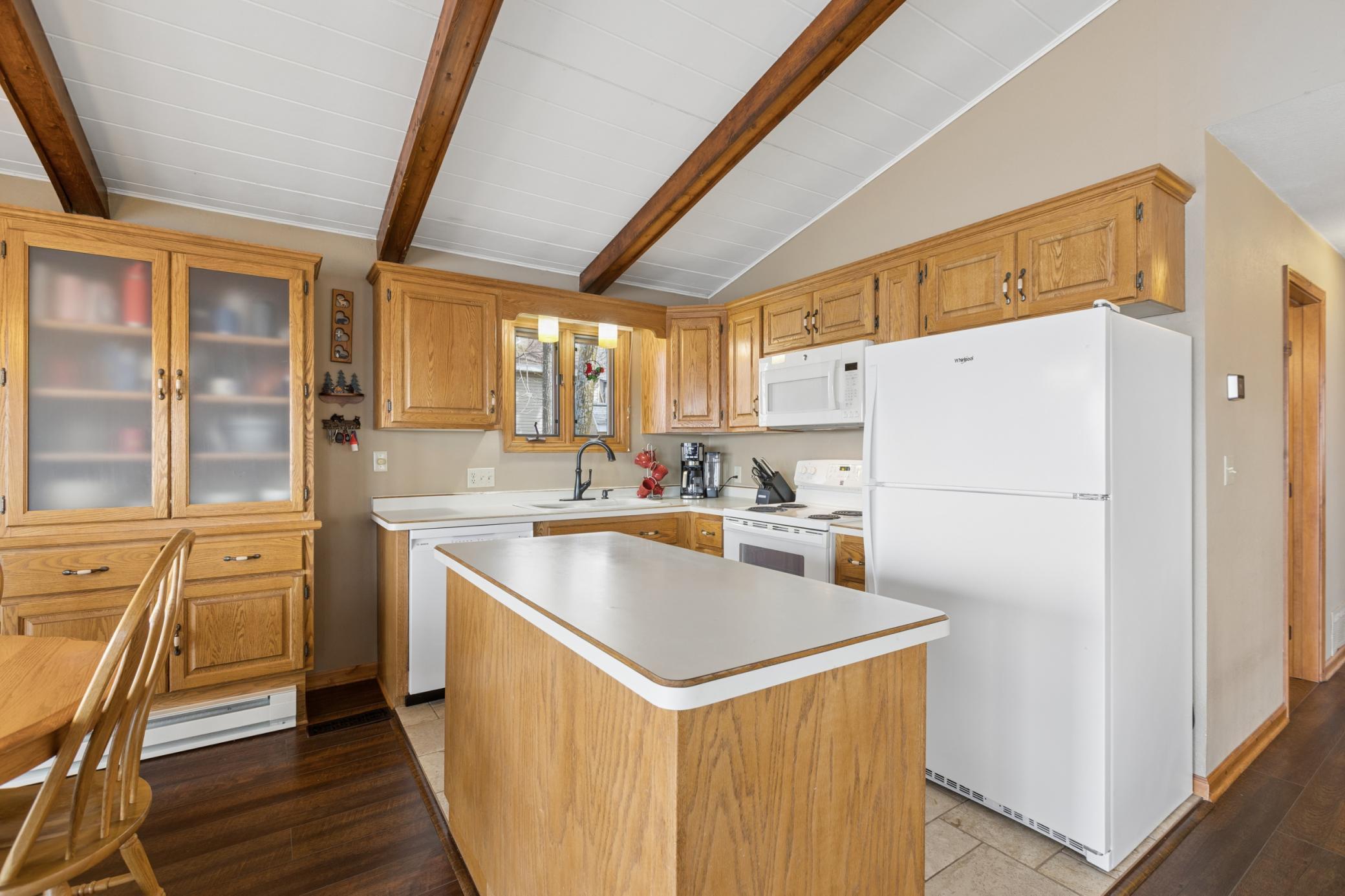 The kitchen with center island allows for everyone to be together from the dining room to the living room and even out to the lakeside deck.
