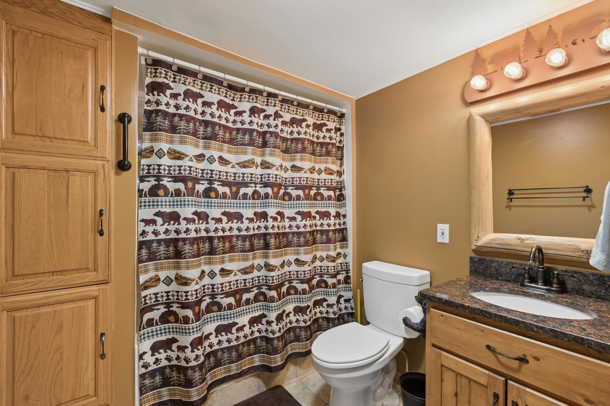 The lower level full bath features tile floors and a jetted soaking tub.