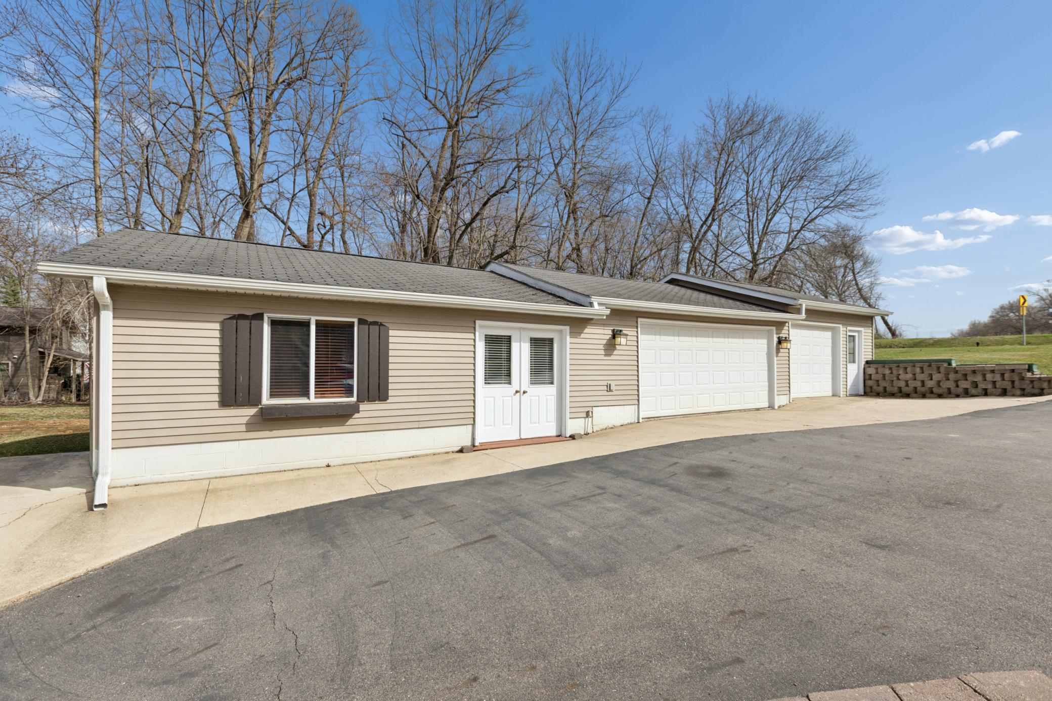 Rare 3-stall garage offers generous storage for boats, ATVs, and all your lake toys, practical luxury few lakeshore homes provide. The left side of this structure has been built out into a bunk house or entertaining space.