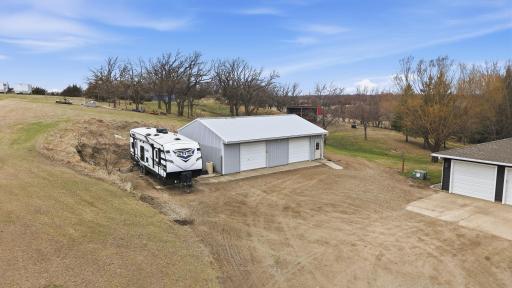 Large 40x28 shed/shop. Full concrete. Half the shed is insulated and heated. Garage door openers on both sides! This shed also has RV parking with 110 Circuit and 30 AMP Camper Plug in