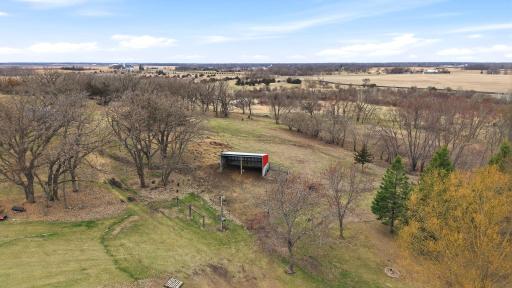 Fenced in Pasture area has a loafing shed for animals. Hand Pump for water