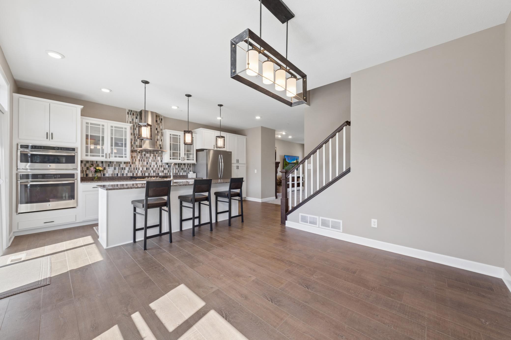 View back towards kitchen with lovely granite counters and huge center island