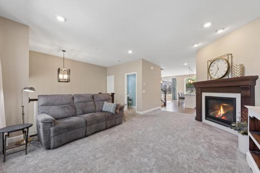 Main floor living room features open layout, 9' ceilings, gas fireplace and a wall of windows for lots of natural light