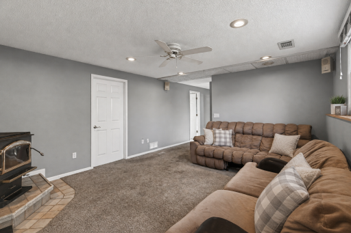Recessed lighting and lookout windows ensure this lower level is bright and inviting.