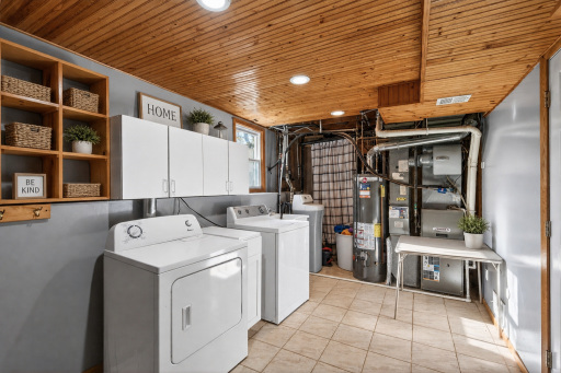 Lower level laundry room with space for storage.