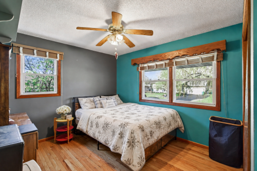 First main floor bedroom has hardwood floors, dual windows for abundant natural light, and a ceiling fan for added comfort year round.