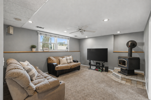 Downstairs, a spacious family room with a wood-burning stove extends your living and entertaining space.